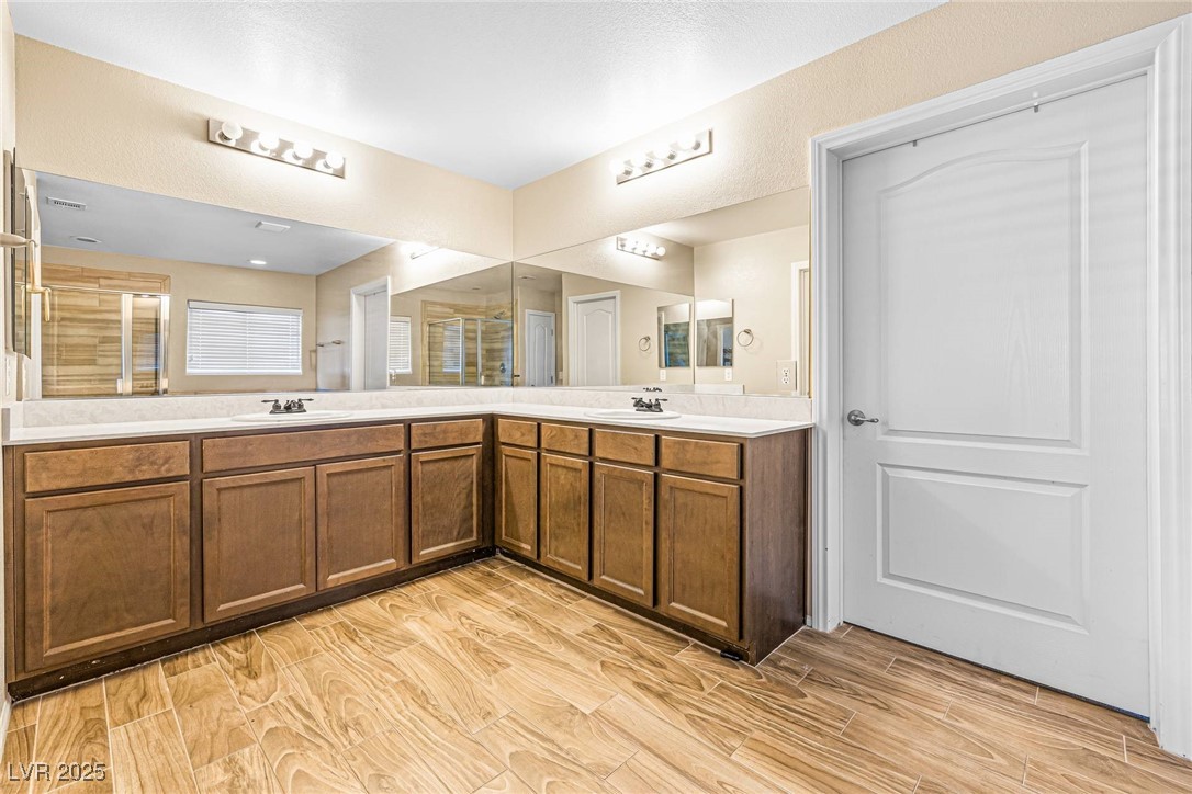 10523 Laurel Mountain Lane Las Vegas, NV 89166 - Photo 15 of 36 Primary Full bath with wood finished floors and double vanity