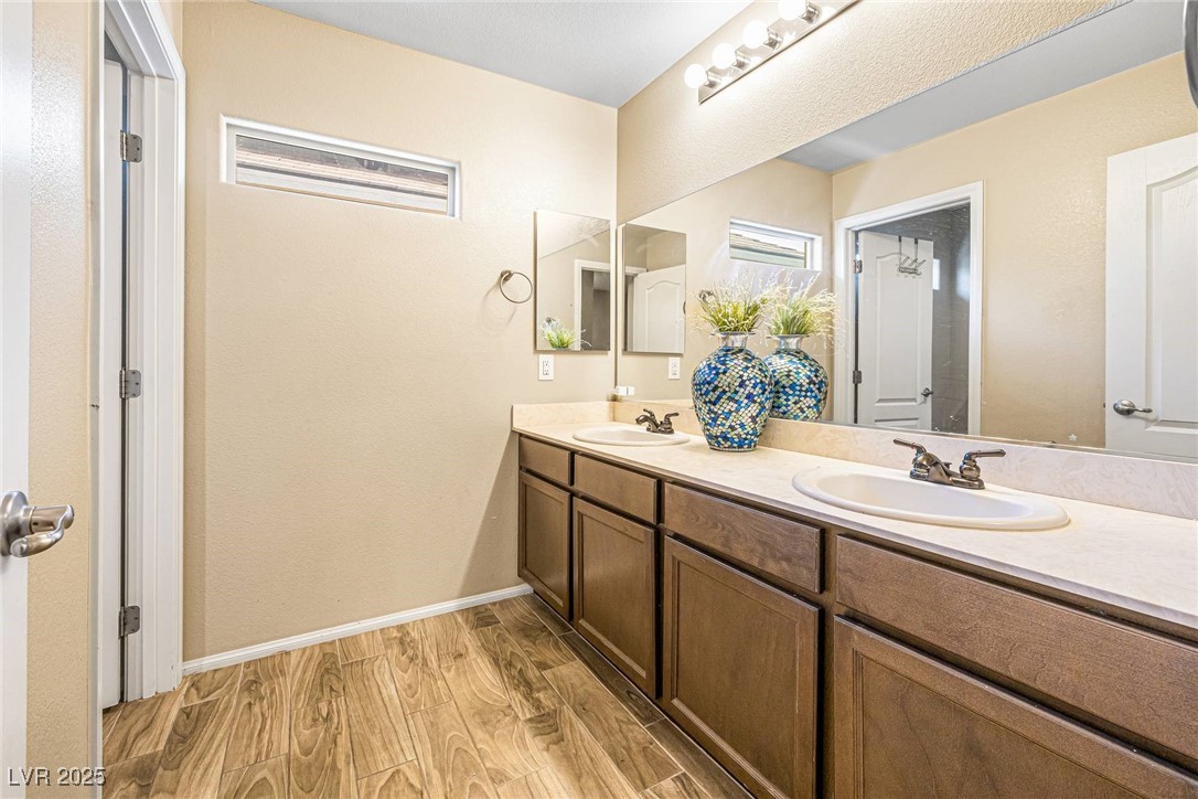 10523 Laurel Mountain Lane Las Vegas, NV 89166 - Photo 20 of 36 3rd Bathroom with wood finished floors, double vanity, and a textured wall