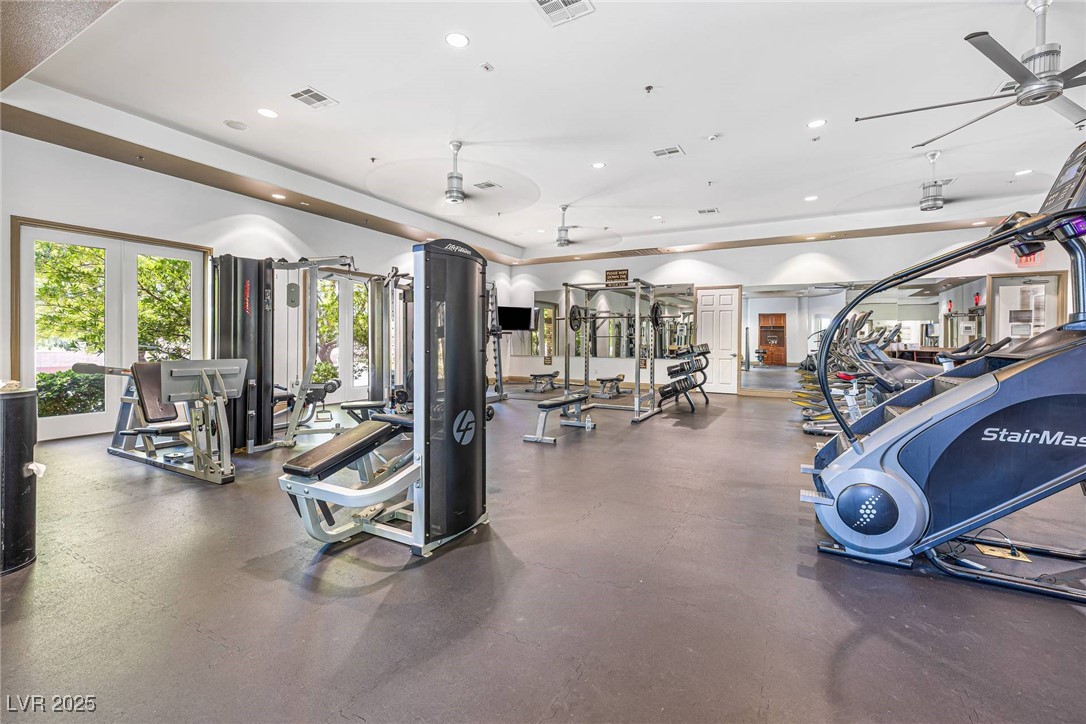 10523 Laurel Mountain Lane Las Vegas, NV 89166 - Photo 28 of 36 Gym with a tray ceiling, recessed lighting, and a ceiling fan