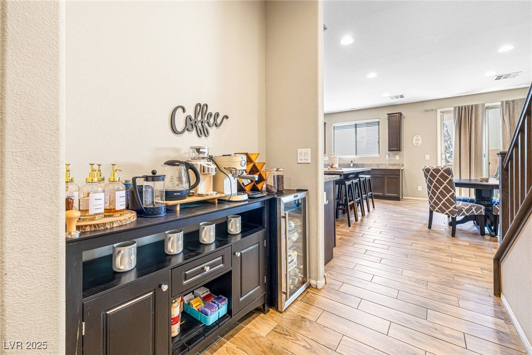 10523 Laurel Mountain Lane Las Vegas, NV 89166 - Photo 3 of 36 Coffee Bar Area featuring light wood-style floors, recessed lighting, beverage cooler, and stairway