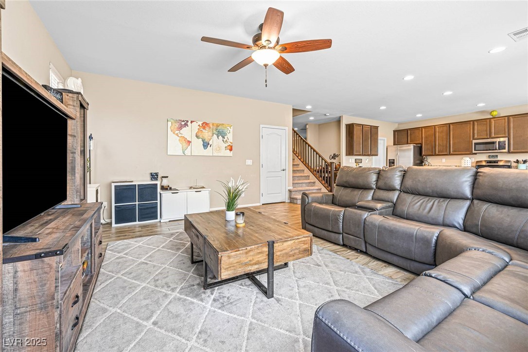 10523 Laurel Mountain Lane Las Vegas, NV 89166 - Photo 36 of 36 Family area featuring a ceiling fan, recessed lighting, and stairway
