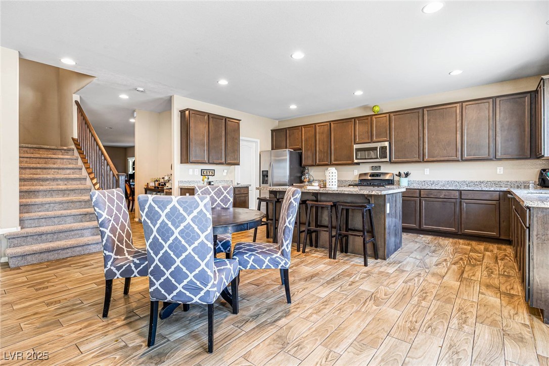 10523 Laurel Mountain Lane Las Vegas, NV 89166 - Photo 4 of 36 Breakfast area featuring stairs, recessed lighting, and light wood-style flooring