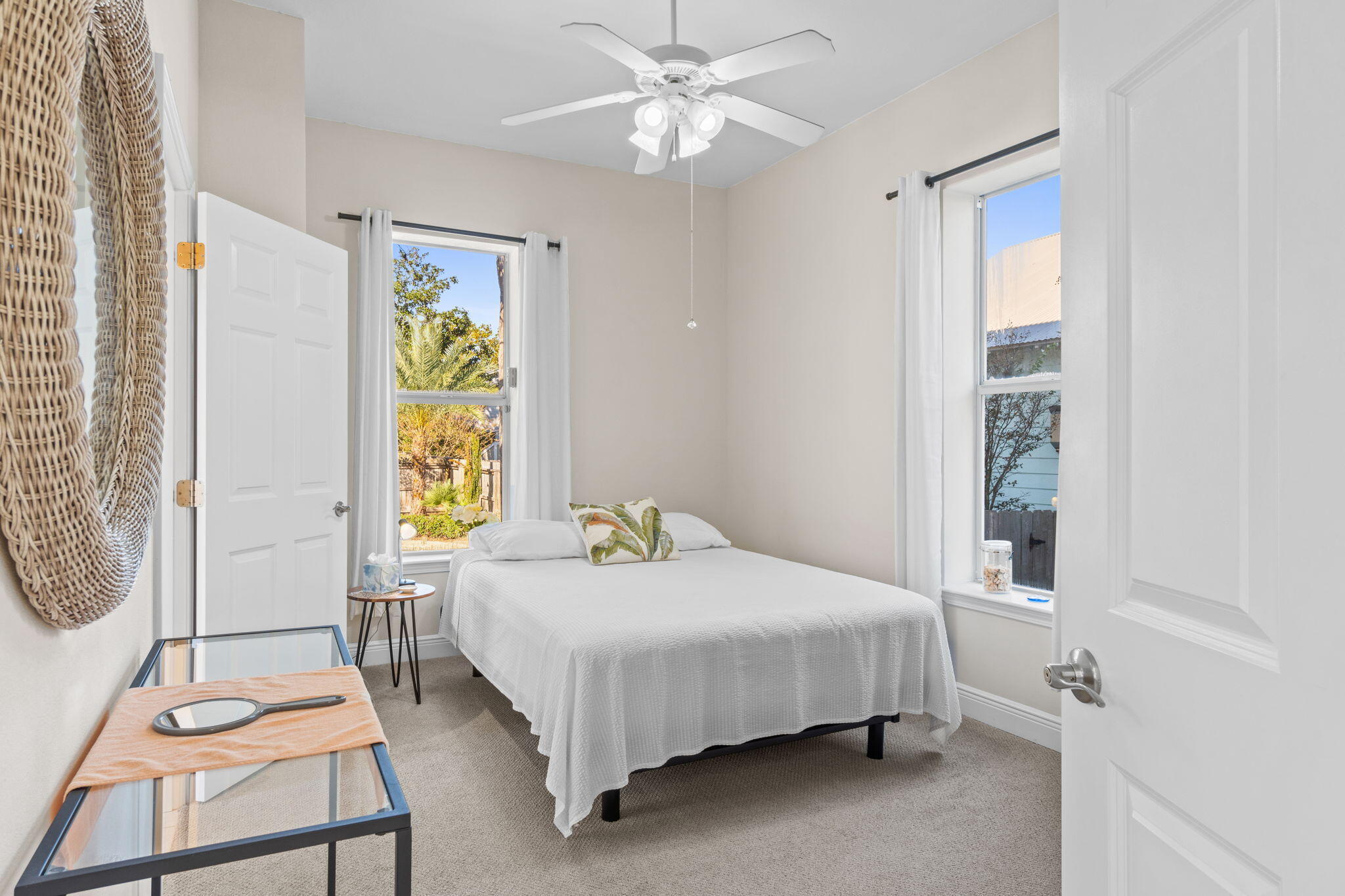 80 Dolphin Street Destin, FL 32541 - Photo 13 of 34 a bedroom with a bed a chandelier and a window