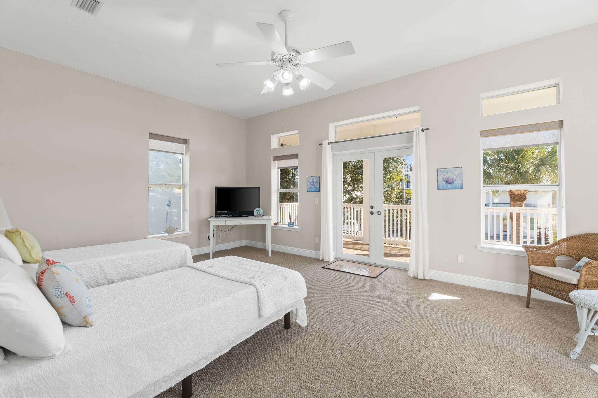 80 Dolphin Street Destin, FL 32541 - Photo 20 of 34 a spacious bedroom with a large bed and a chandelier