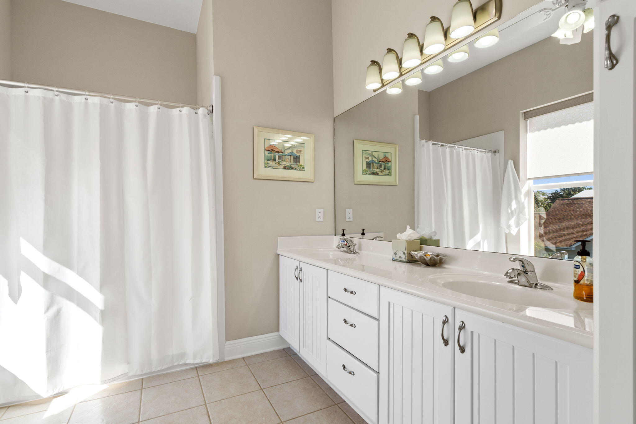80 Dolphin Street Destin, FL 32541 - Photo 24 of 34 a bathroom with a double vanity sink a mirror and a shower