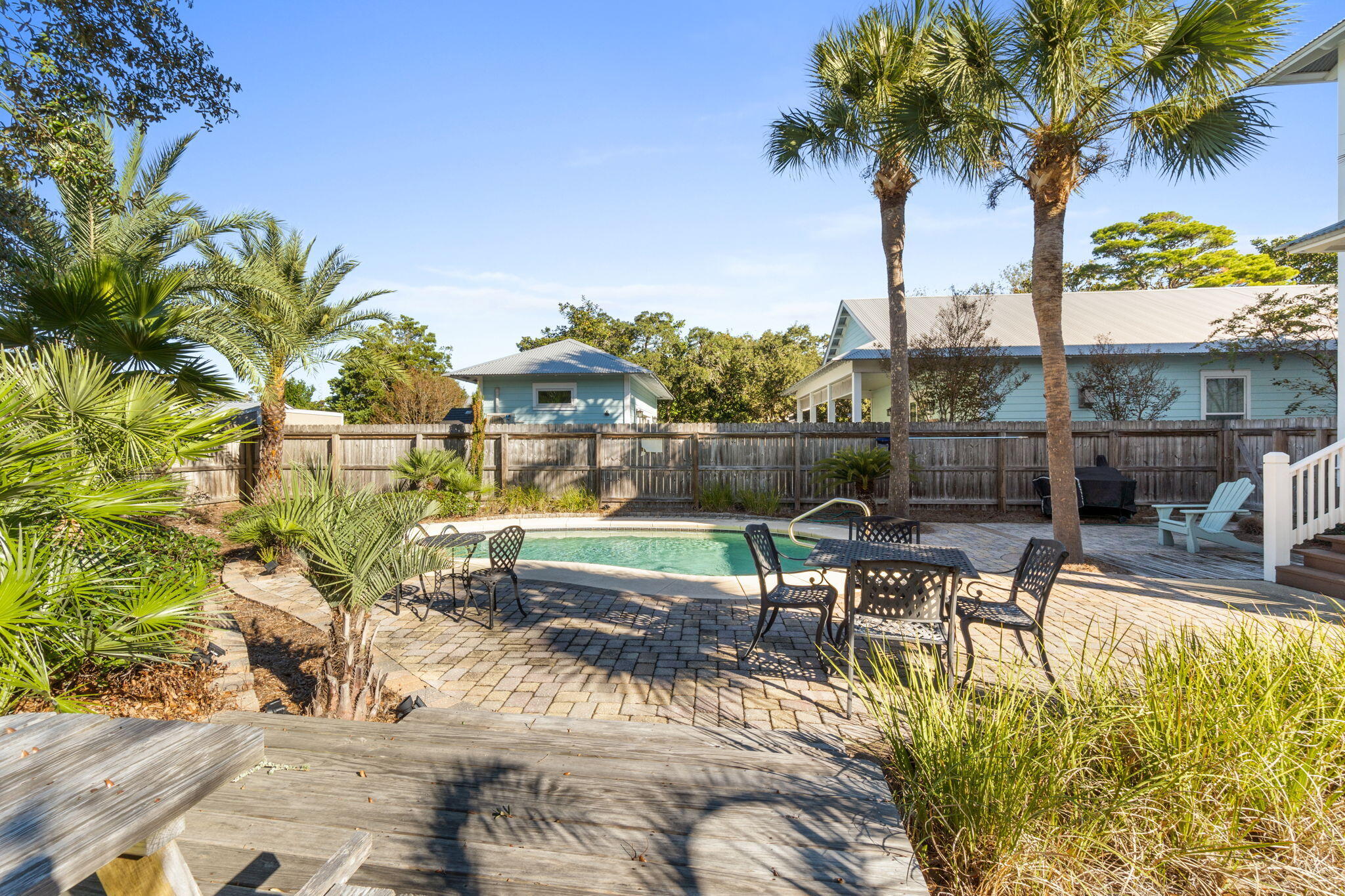 80 Dolphin Street Destin, FL 32541 - Photo 34 of 34 a view of a swimming pool with a patio and a garden