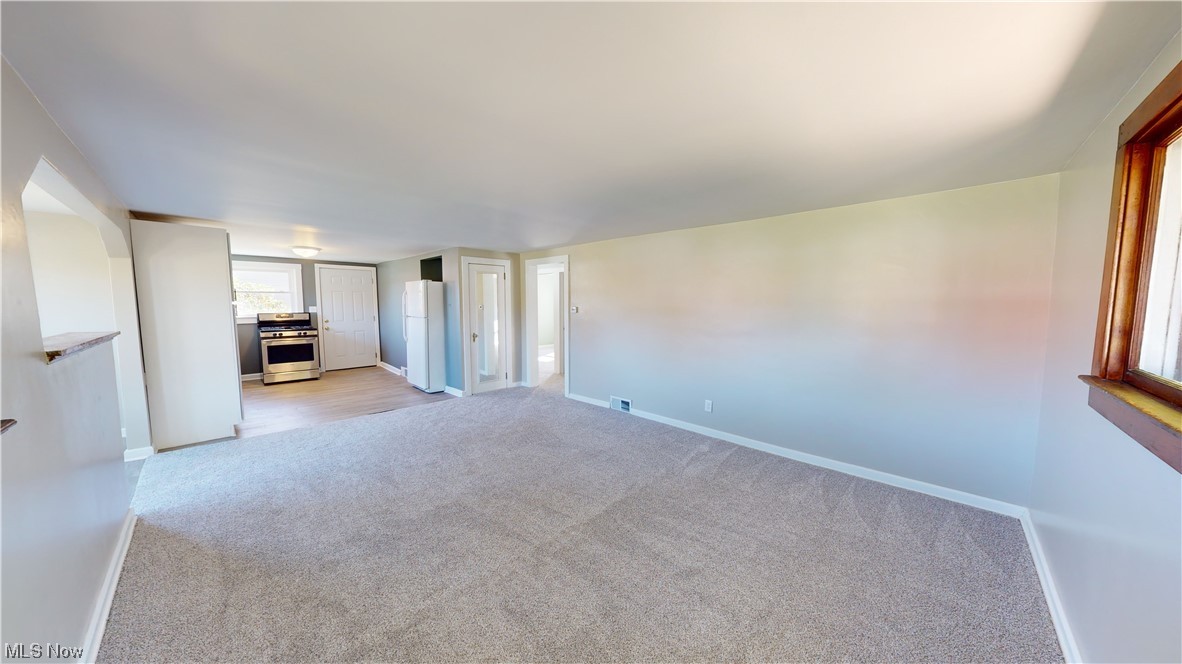 852 East Waterloo Road Akron, OH 44306 - Photo 12 of 24 Unfurnished living room with light colored carpet