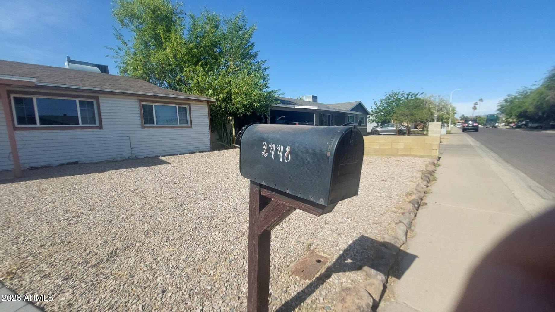 2448 West Freeway Lane Phoenix, AZ 85021 - Photo 2 of 27 a sign board with wooden fence