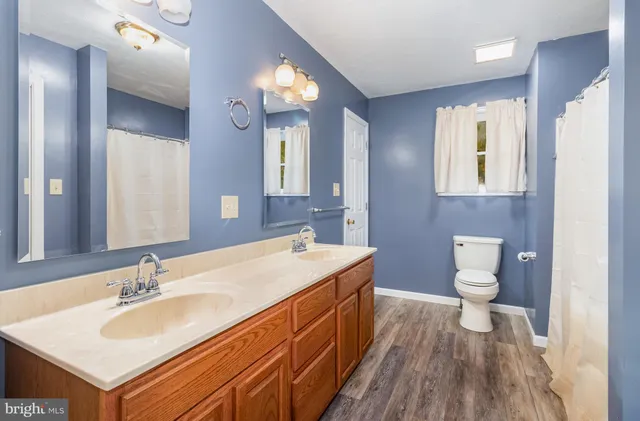 an empty room with closet and a chandelier fan