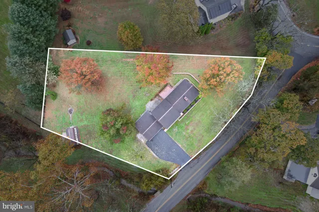 a front view of a house with a garden and yard