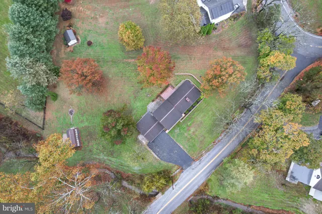 a aerial view of a house with pool yard and outdoor seating