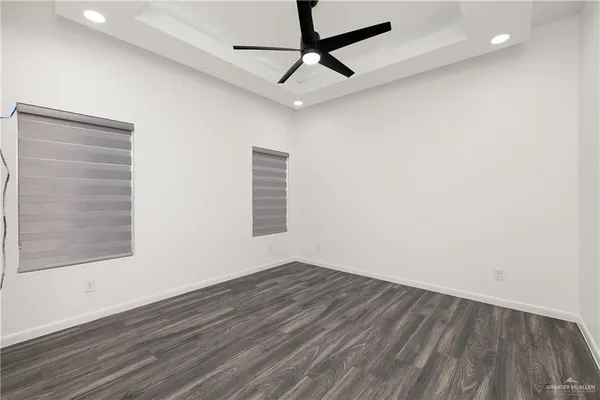 a view of a room with wooden floor and white walls