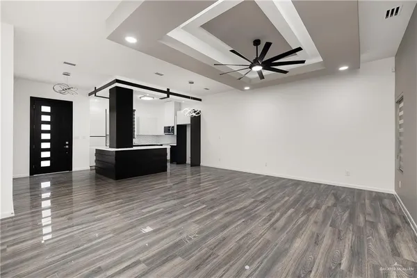 a view of a livingroom with a hardwood floor and a ceiling fan