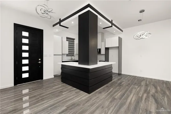 a spacious bedroom with a bed and a dresser