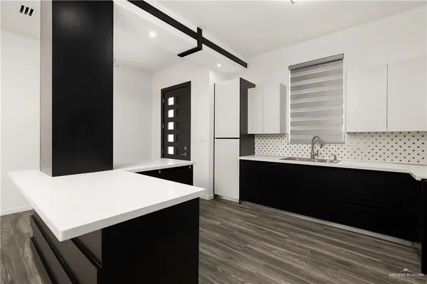 a kitchen with a sink and cabinets