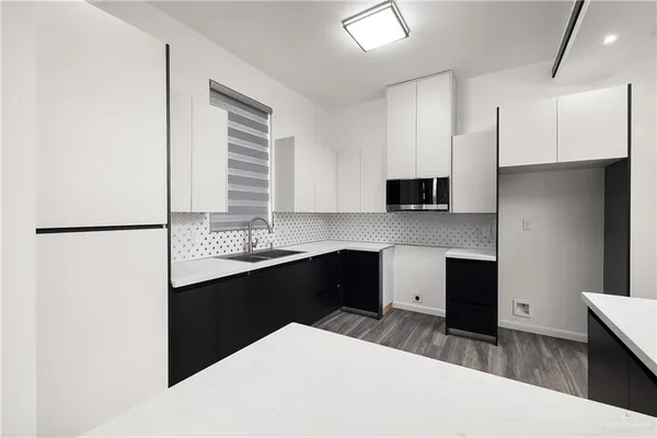 a kitchen with a refrigerator and a sink