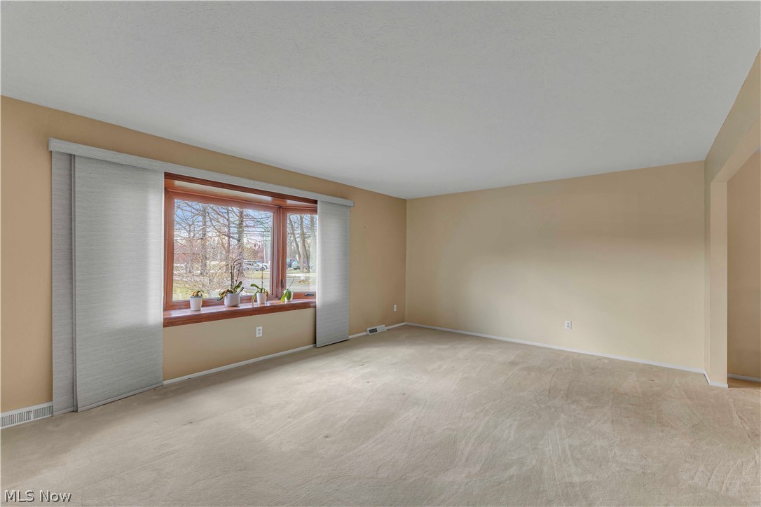 563 North Carpenter Road Brunswick, OH 44212 - Photo 6 of 45 Unfurnished room with light carpet and baseboards
