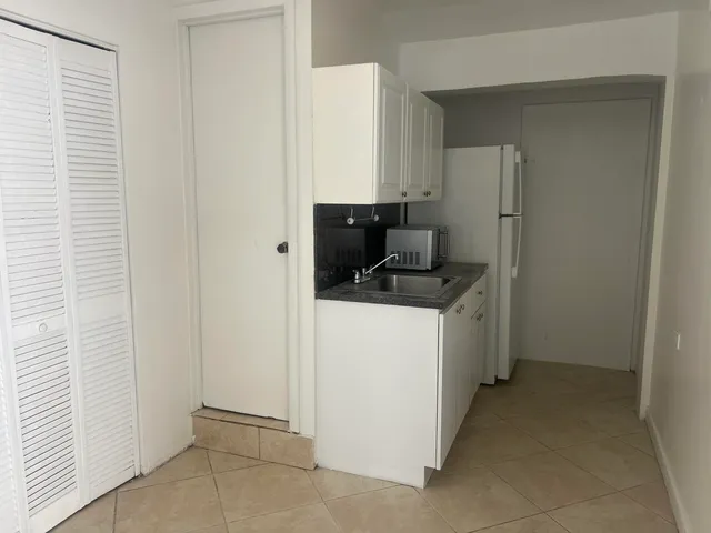 a kitchen with a sink and refrigerator