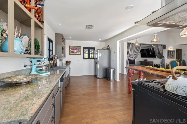 a kitchen with stainless steel appliances granite countertop a stove and a sink