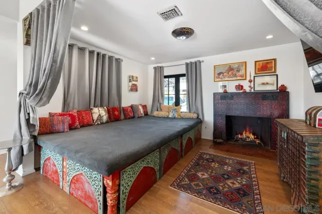 an outdoor kitchen with a fireplace and breakfast area