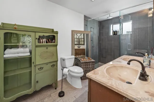 a bedroom with a bed window and a desk