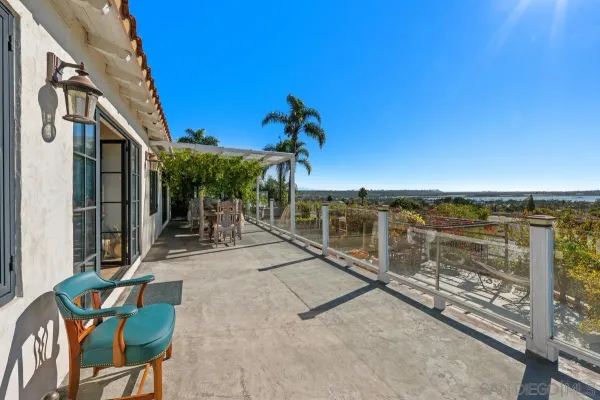 a view of a chairs and table in the balcony