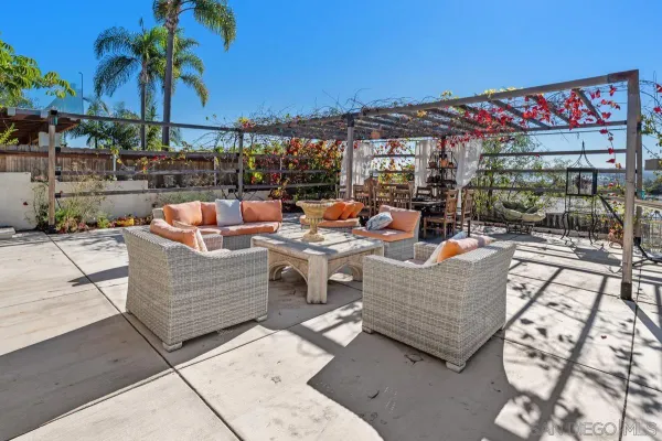 a view of a patio with table and chairs and potted plants