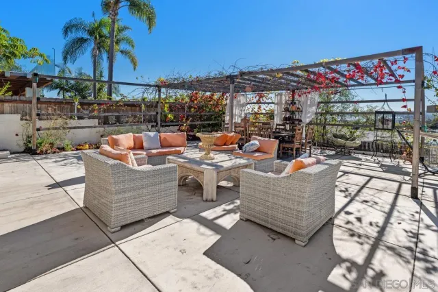 a view of a patio with table and chairs and potted plants