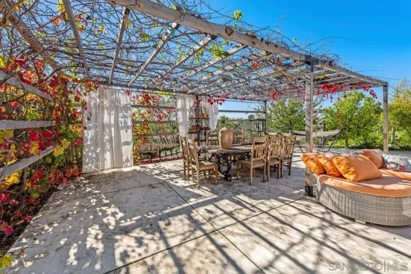 a view of a house with backyard and sitting area