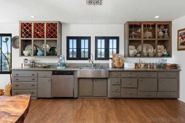 a kitchen with granite countertop a stove and cabinets