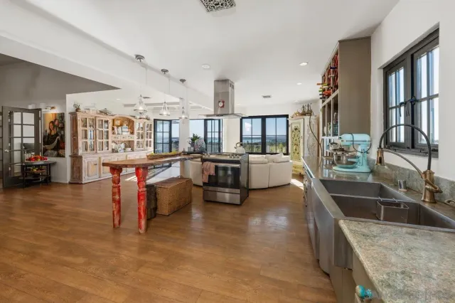 a kitchen with stainless steel appliances kitchen island granite countertop a sink and cabinets