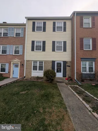 a view of a brick building next to a yard