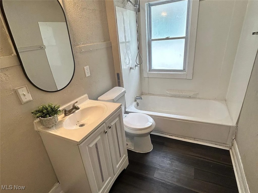 13902 Coit Road Cleveland, OH 44110 - Photo 12 of 17 Full bathroom featuring shower / tub combination, vanity, wood-type flooring, and toilet