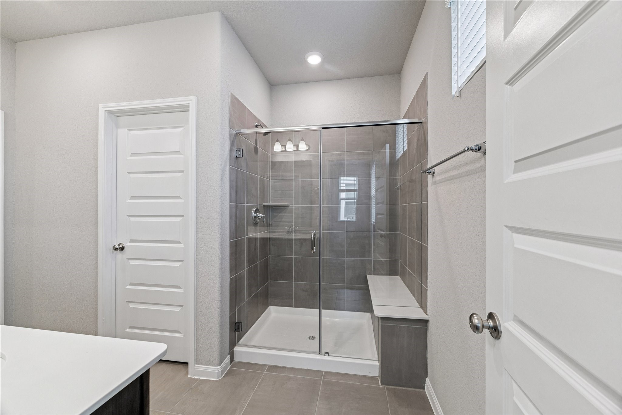 5502 Cuerta Street Houston, TX 77023 - Photo 17 of 25 Second primary bathroom with a walk-in shower and closet! Luxurious bench in the shower is a bonus.