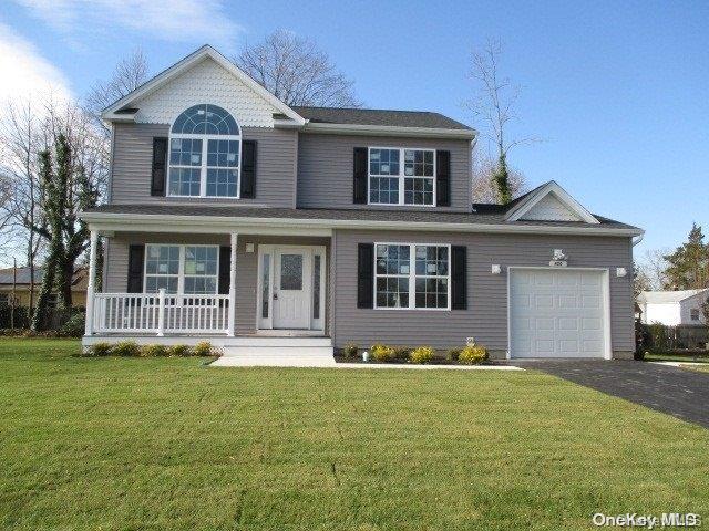 Lot 2136 Carle Road Bellport, NY 11713 - Photo 1 of 1 a front view of a house with a yard