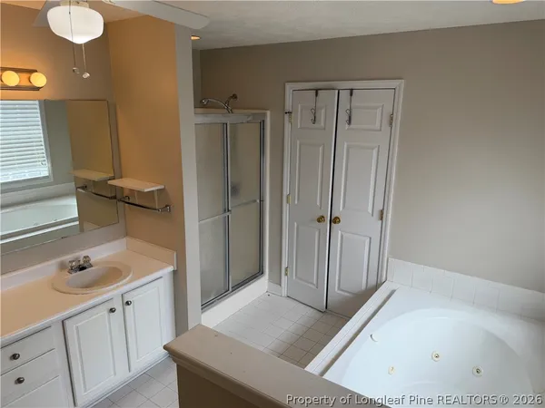 a bathroom with a tub sink and mirror