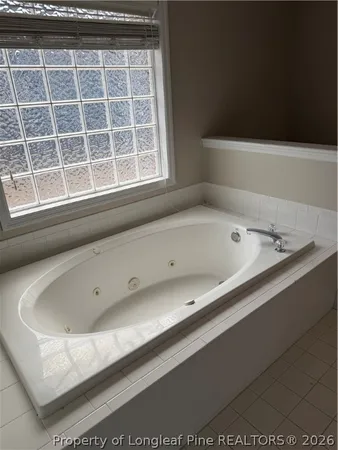 a bath tub sitting next to a window