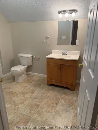 a bathroom with a sink a toilet and mirror