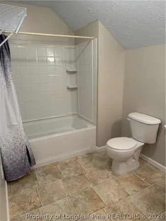 a bathroom with a toilet and shower