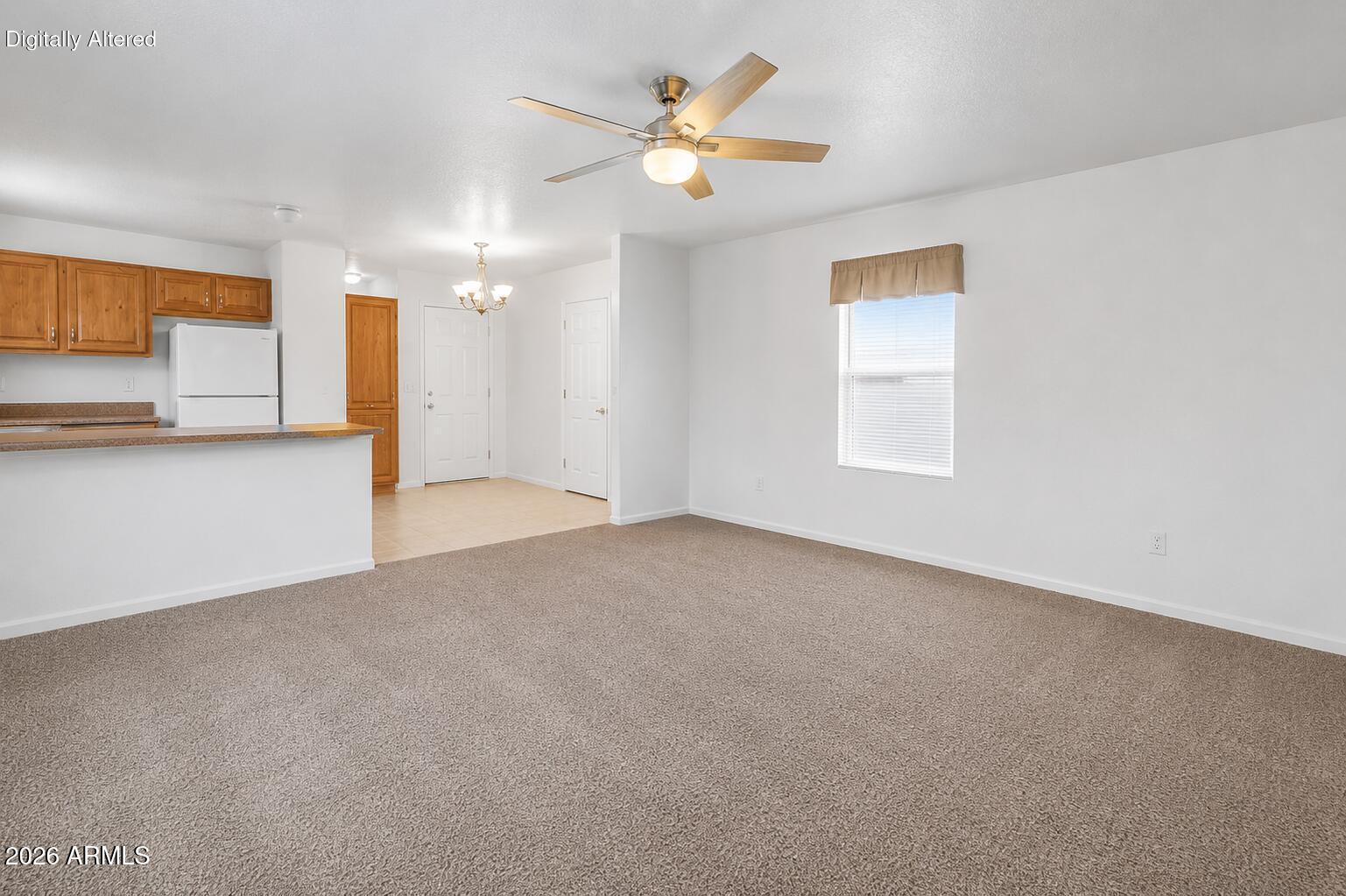 625 West McKellips Road, Unit 55 Mesa, AZ 85201 - Photo 4 of 21 a view of a livingroom with a ceiling fan and window