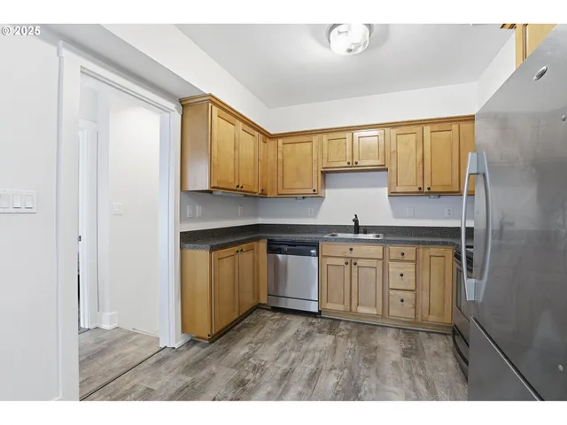 a kitchen with granite countertop a sink and a stove top oven