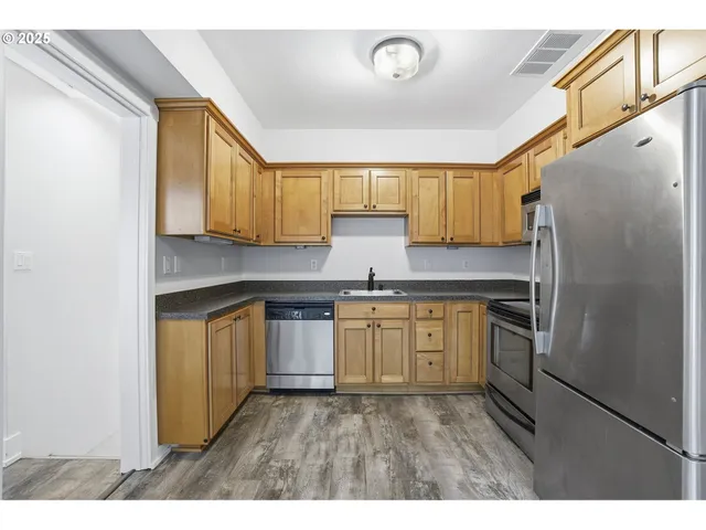 a kitchen with granite countertop a refrigerator and a stove