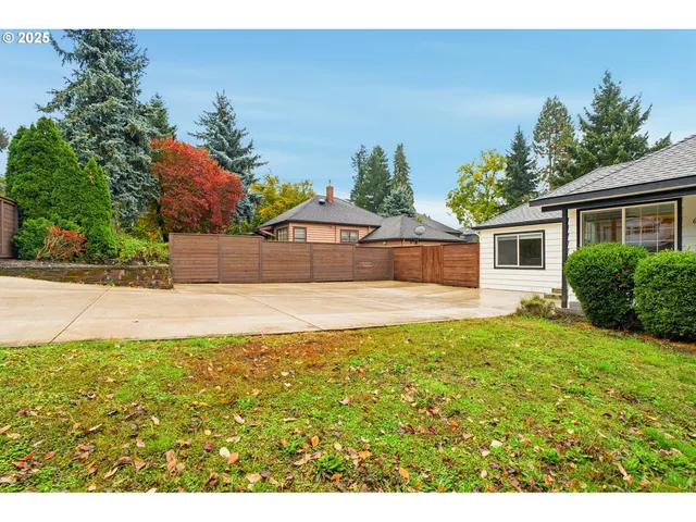 a view of a house with pool and a yard