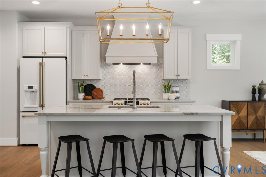 13800 Summerlook Lane Chesterfield, VA 23832 - Photo 12 of 49 a kitchen with stainless steel appliances a dining table chairs and stove