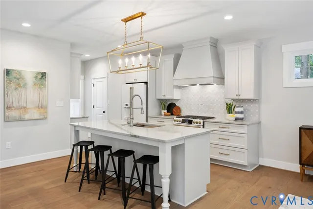 a kitchen with cabinets a sink stainless steel appliances and window