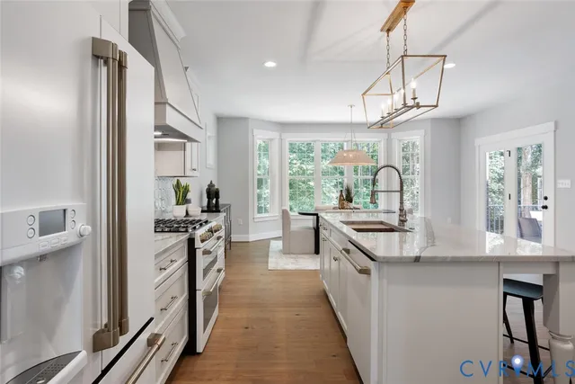 a kitchen with stainless steel appliances a stove sink and refrigerator