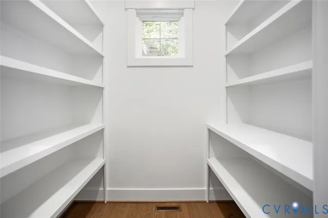 a view of room with window and wooden floor