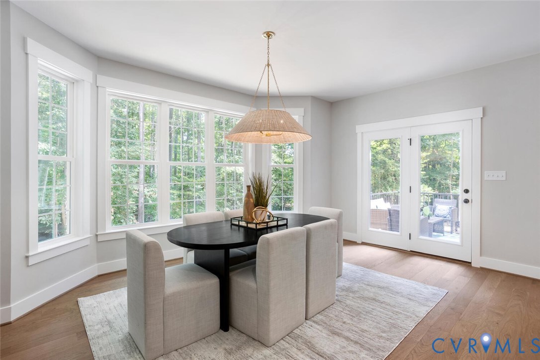 13800 Summerlook Lane Chesterfield, VA 23832 - Photo 21 of 49 a dining room with wooden floor and a chandelier