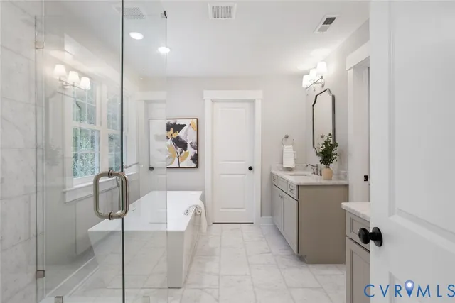 a spacious bathroom with a shower sink and mirror