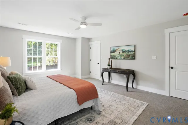 a bedroom with a bed a table and painting